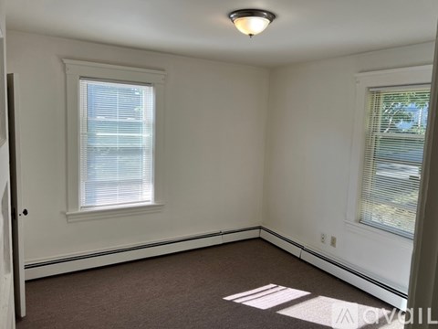 A room with a window and a door.