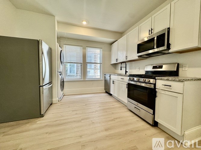A kitchen with white cabinets and stainless steel appliances.