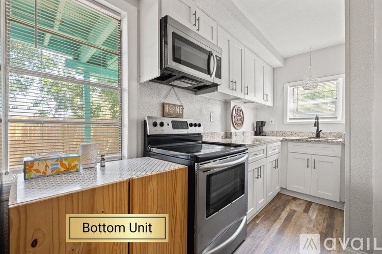 A kitchen with a stove top oven and microwave.