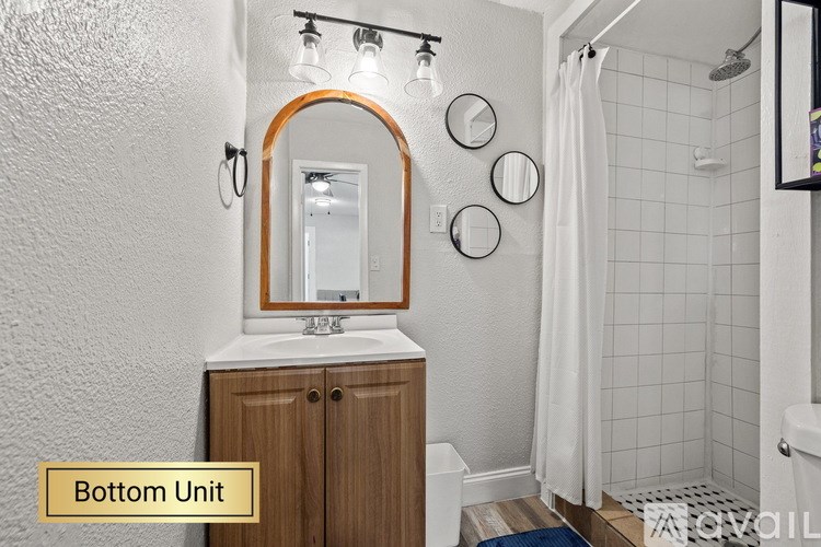 A bathroom with a white shower curtain and a white tiled shower wall.