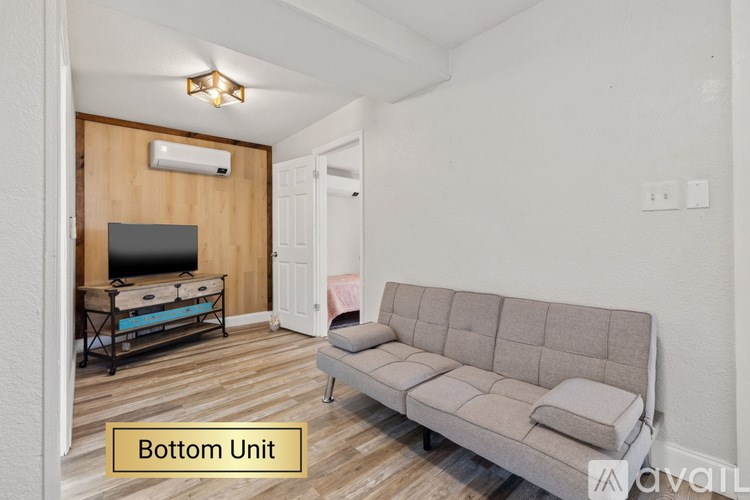 A living room with a grey sofa and a television.