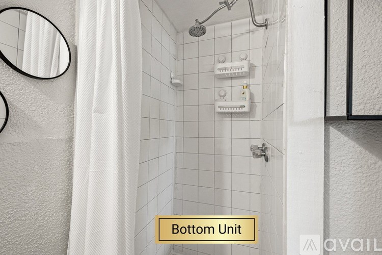 A bathroom with a white shower curtain and a mirror on the wall.
