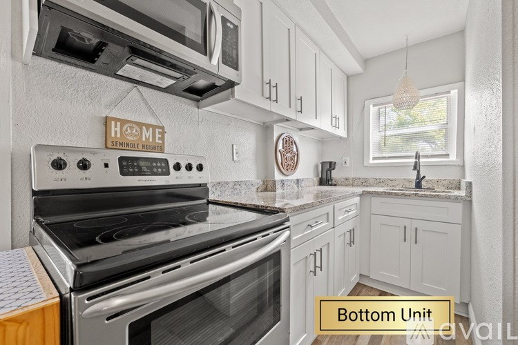 A modern kitchen with a stove top oven and a sign that says "Home".