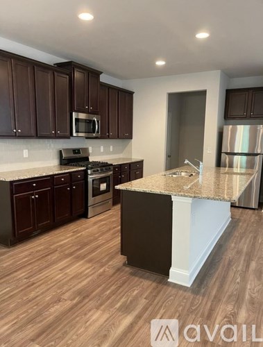 A kitchen with brown cabinets and a white island.