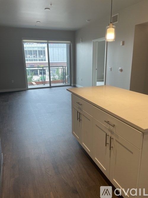A kitchen with white cabinets and a wooden countertop.