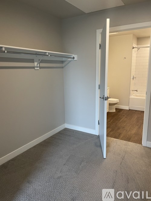 A room with a white door leading to a bathroom.