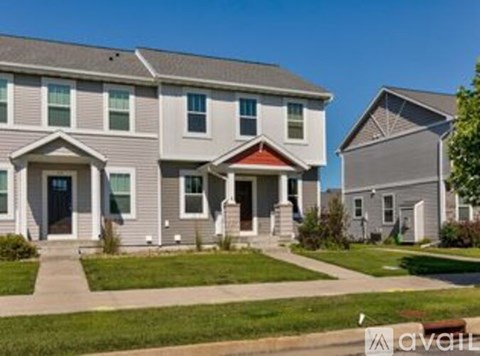 A row of houses with the first one having a red door.