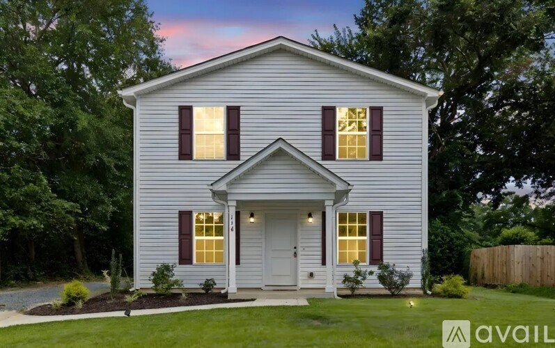 A house with a front yard and a fence.