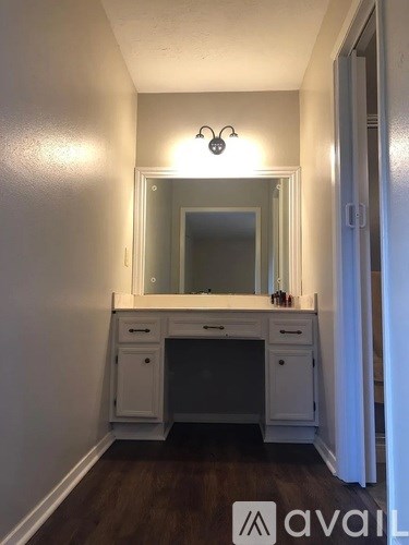 A bathroom vanity with a mirror above it.