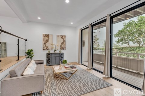 A living room with a grey sofa and a wooden coffee table.