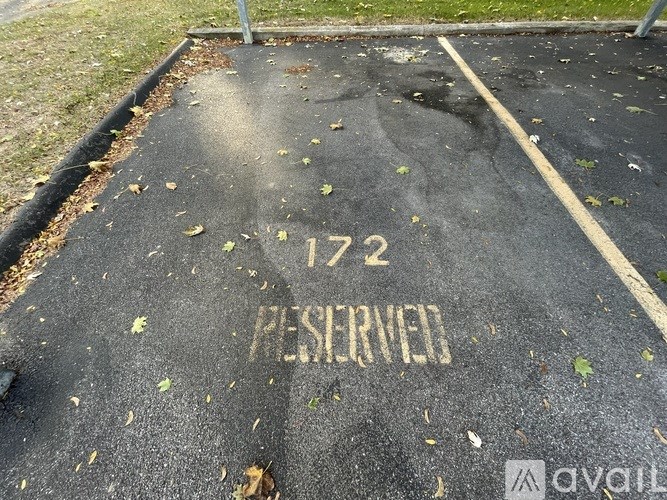 A parking space with the number 172 and the word "reserved" painted on it.