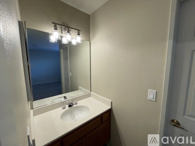 A bathroom with a sink and mirror.