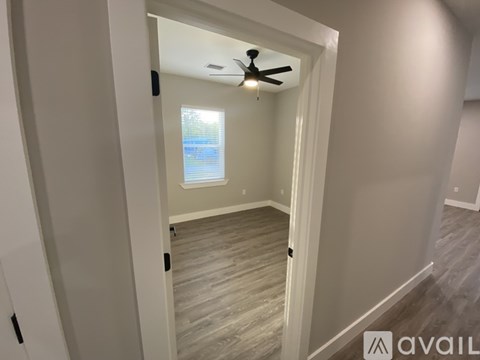A room with a ceiling fan and a window.