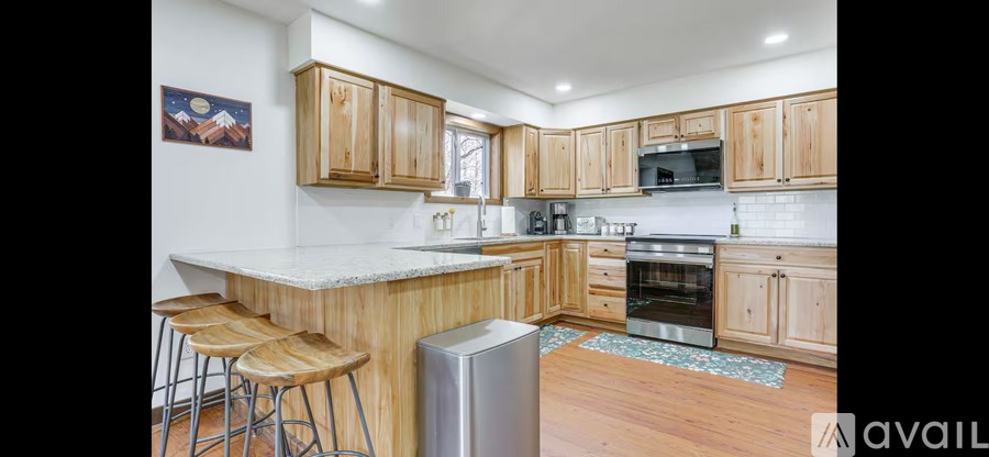 A kitchen with wooden cabinets and a white countertop.