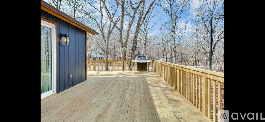 A wooden deck with a blue building and a sign that says "available".