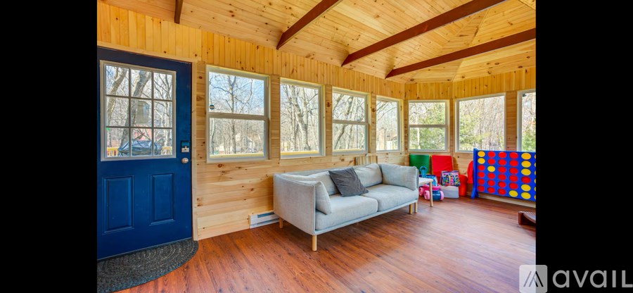 A room with wooden walls and a blue door.