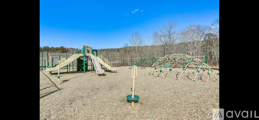 A playground with a slide, swings, and a climbing structure.