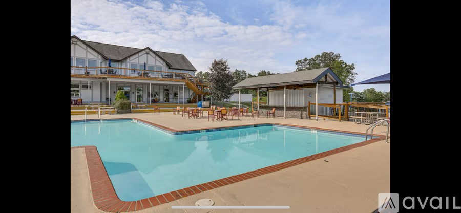 A large swimming pool with a building in the background.