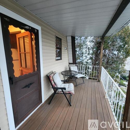 A wooden deck with a table and chairs.