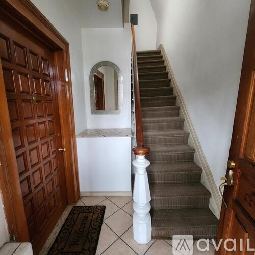 A staircase with a mirror on the wall.