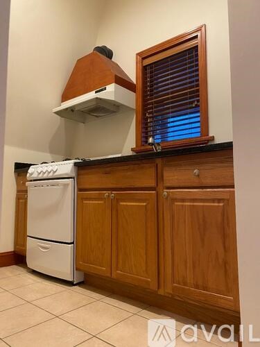 A kitchen with wooden cabinets and a white dishwasher.