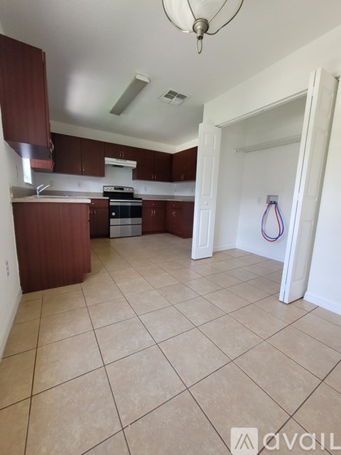 A kitchen with brown cabinets and a white door.