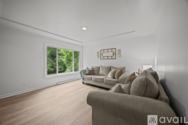 A living room with a couch and a window.