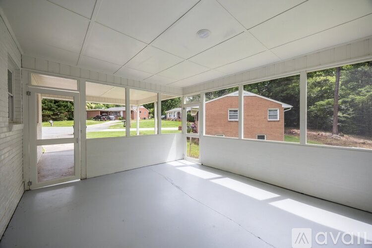 A large empty room with white walls and a white ceiling.