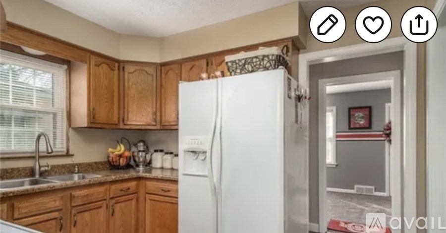 A kitchen with wooden cabinets and a white refrigerator.