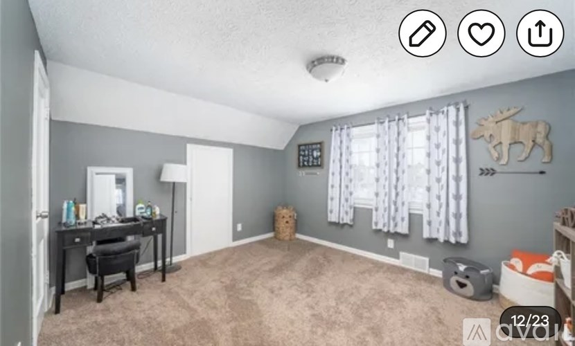 A room with a desk and a chair in it.