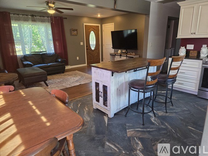 A living room with a wooden bar and a television.