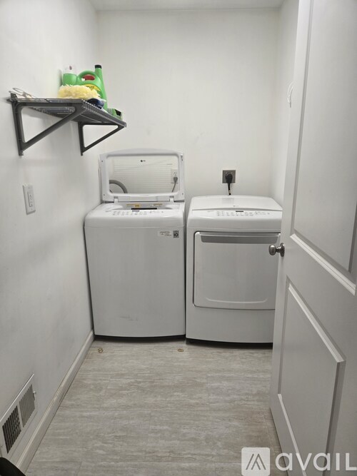 A small laundry room with a washer and dryer.