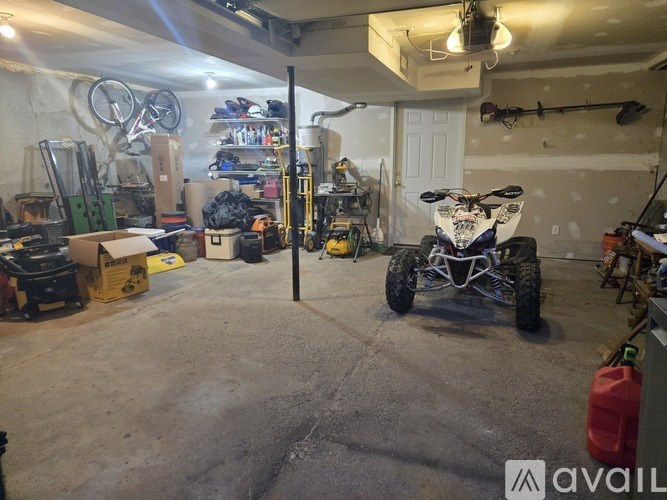 A garage with a vehicle and tools.