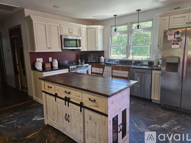 A kitchen with wooden cabinets and a central island.