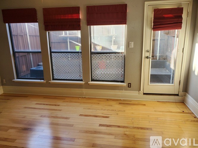 A room with wooden floors and a sliding glass door.