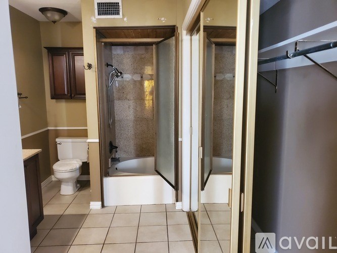 A bathroom with a toilet, sink, and shower.