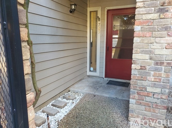 A red door is on the right side of a house.