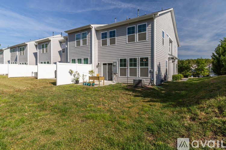 A row of houses with a grassy area in front.