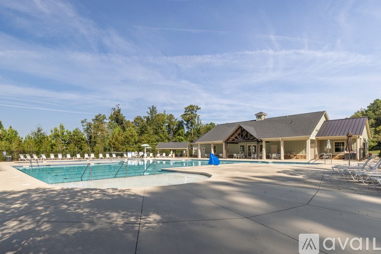 A large house with a pool in front of it.