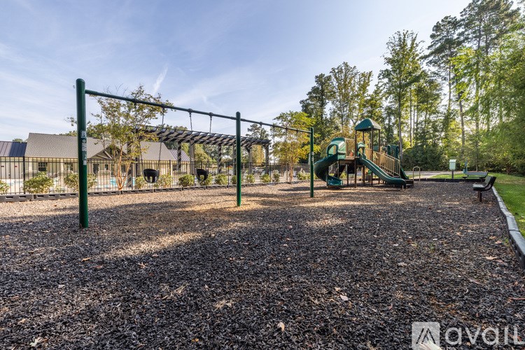 A playground with a swing set and a slide.