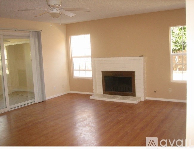 A living room with a fireplace and sliding glass doors.