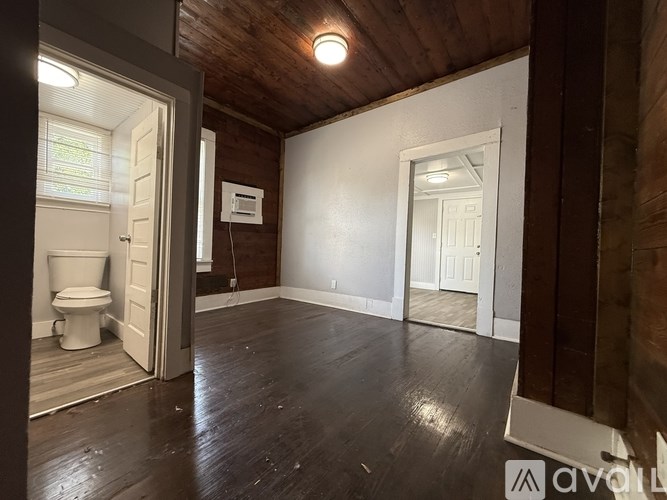 A room with wooden floors and white walls.