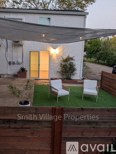A patio area with a white chair and a table.