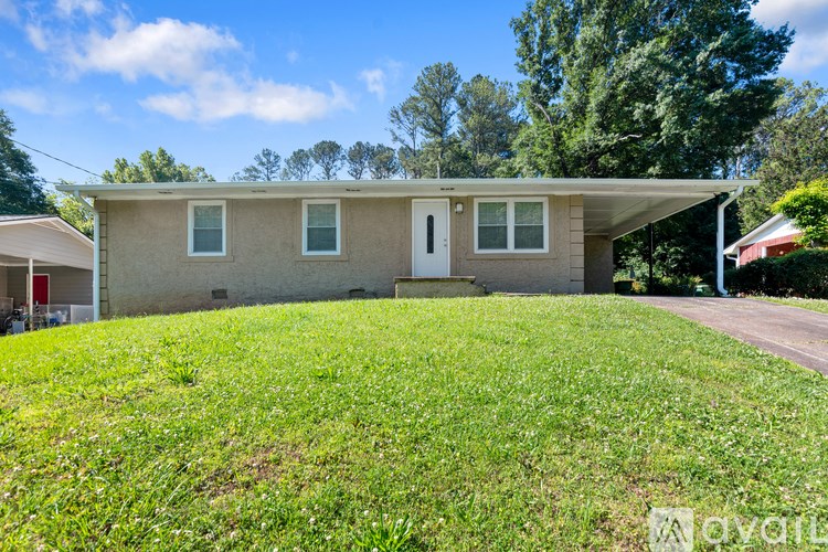 A house with a green lawn in front of it.