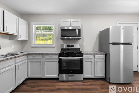 A kitchen with white cabinets and stainless steel appliances.