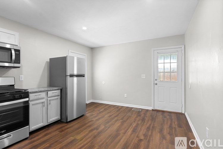 A kitchen with a stainless steel refrigerator, oven, and microwave.