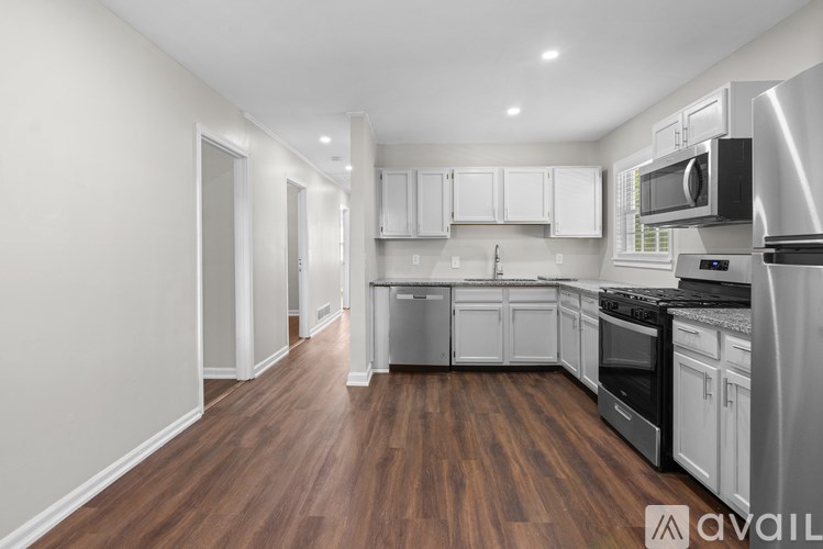 A kitchen with white cabinets and stainless steel appliances.