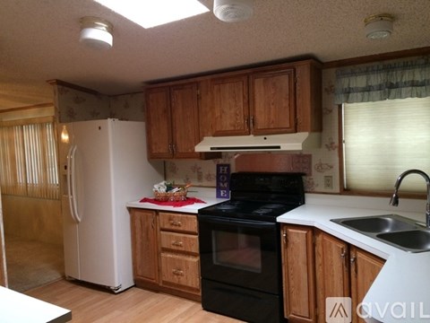 A kitchen with wooden cabinets and a black stove top oven.