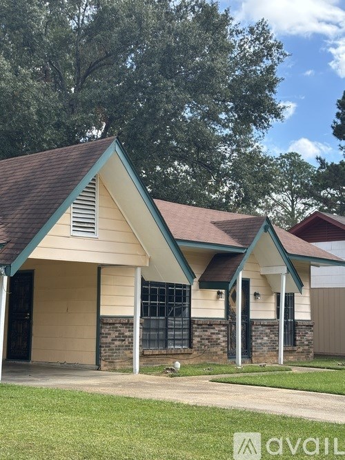 A house with a brown roof and a green trim.