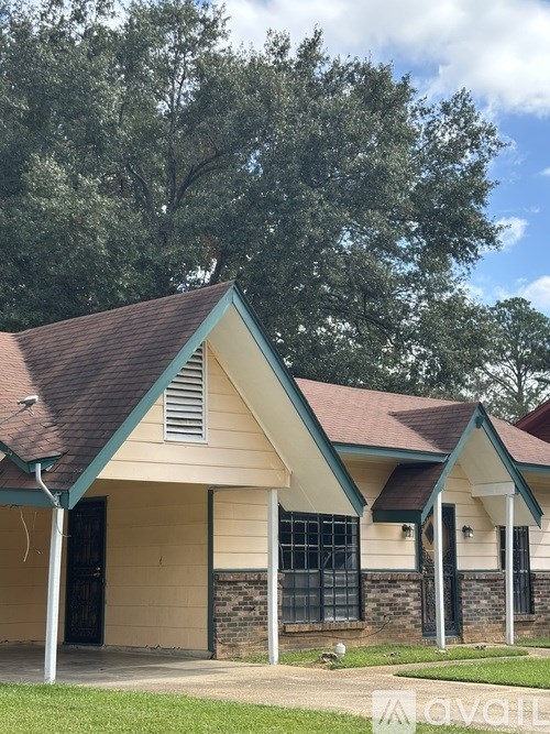 A house with a brown roof and a green trim.